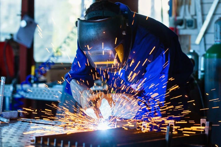 Soudeur avec son casque soudant des pièces